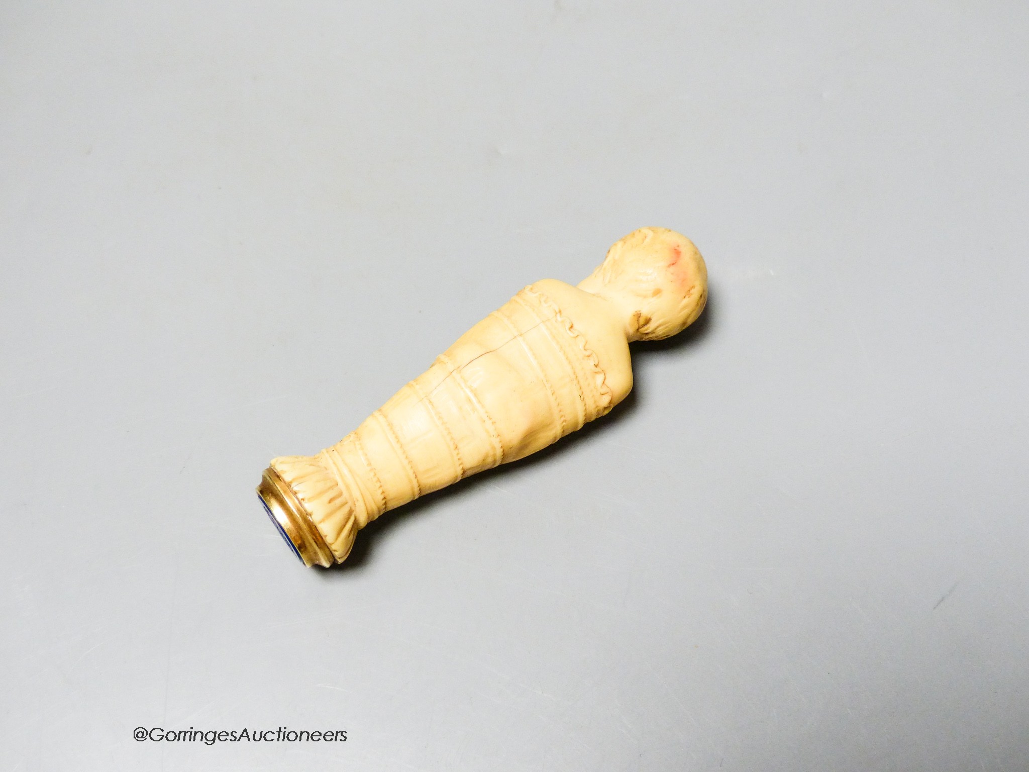 A 19th century or earlier carved ivory and lapis lazuli swaddling infant seal, length 10cm